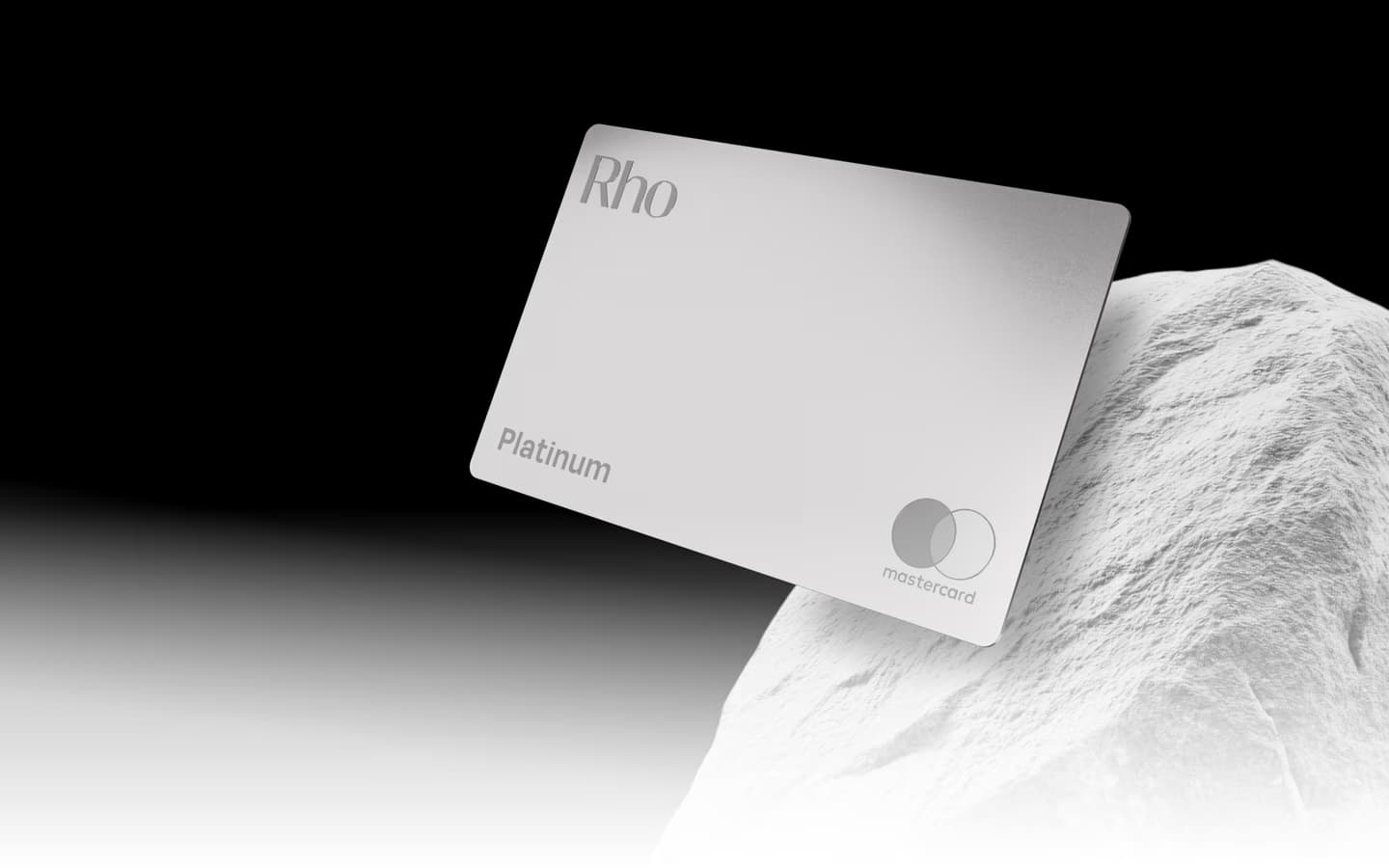 Image of white and gray Rho credit card on rock